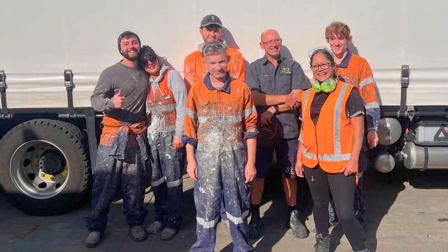 Team photo of seven construction workers on site